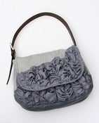 Image of a large tough ruffles shoulder bag in two shades of grey
