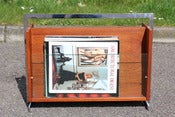 Image of British Merrow Associates style teak and chromed steel magazine rack circa 1960/70s