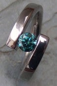 Image of Titanium Twist of Fate Tension Set Band 1/2 Carat Certified Blue Diamond Ring