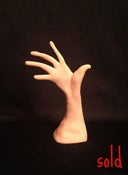 Image of A sculpture of a beautiful curved hand