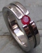 Image of Titanium Striped Tension Set Band - Round Cut Red Ruby Ring