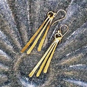 Image of brass three feather earrings