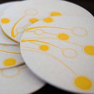 Image of dancing oranges letterpress coasters round, set of 8