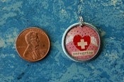 Image of Pink Badge of Peregrination charm
