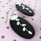 Image of leaf vines on a black wall earrings
