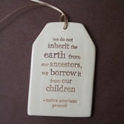 Image of ceramic quote tag - inherit the world