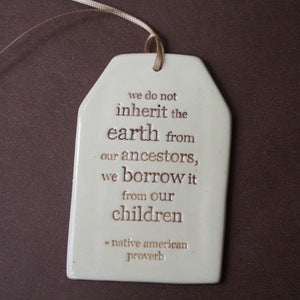 Image of ceramic quote tag - inherit the world