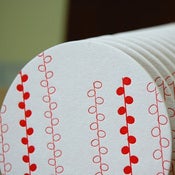 Image of hanging circles letterpress coasters, set of 8