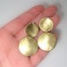 Image of inside out disks. earrings. brass.