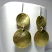 Image of inside out disks. earrings. brass.