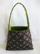 Image of blue chain on brown/ green suede