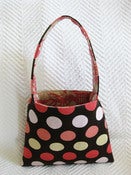 Image of pink polka dot on brown/ pink baby toile