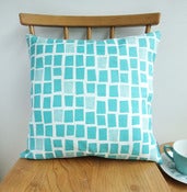 Image of city windows cushion in aqua on white linen