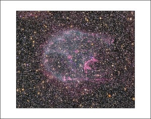Image of Glowing Gas Floats Amid A Myriad Of Stars
