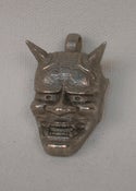 Image of Hannya mask pendant by Matthew Amey