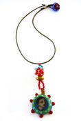Image of bird-in-mouth necklace