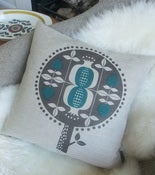 Image of pomegranate tree cushion in teal on natural linen 
