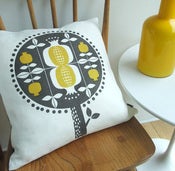 Image of pomegranate tree cushion in yellow on white linen