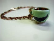 Image of Thick Feather tea cup charm bracelet