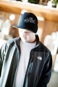 Image of Black knit hat with bill
