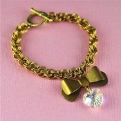 Image of Cutie Pie - Gold Tone Chunky Brass Bow Bracelet with Clear Swarovski Heart