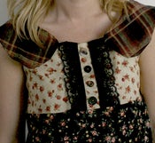 Image of rose print and plaid collar dress with black lace and mismatched buttons down the front