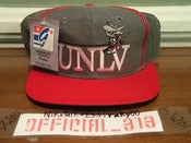Image of VINTAGE UNLV RUNNING REBELS TEXT LOGO THE GAME SNAPBACK CAP HAT