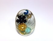 Image of Sterling silver brooch with resin, feathers and vintage beads.