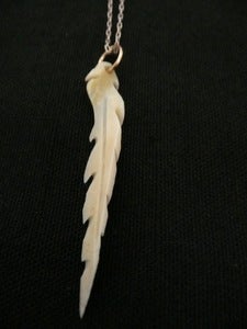 Image of single carved feather