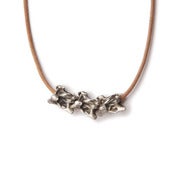 Image of silver triple vertebrae on wax-coated cotton with silver caudal vertebrae closure (P02silB10)