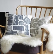 Image of logpile cushion on white linen