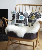 Image of Logpile cushion in black on white linen