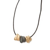 Image of oxidized silver & two brass sheep teeth on wax coated cotton w/ brass button closure (P29silBra20)