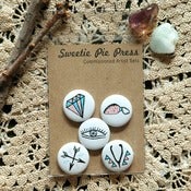 Image of charms commissioned artist button set by sandi falconer.