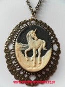 Image of Black Cream Unicorn Necklace on antique gold chain 