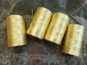 Image of Bundle of 4 spools of yellow thread in wax paper (TX022)