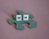 Image of square silver studs, punched