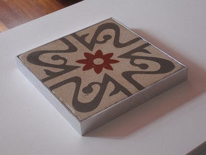 Image of Oxblood flower on grey and creme background trivet