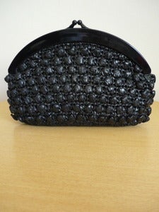 Image of black plastic raffia clutch