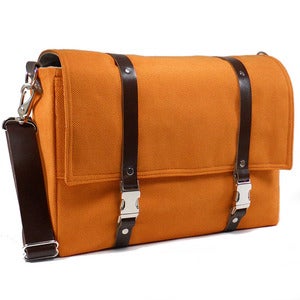 Image of Larger 13" laptop messenger bag with leather strap in orange with brown leather