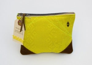 Image of yellow zip pouch with brown suede corners