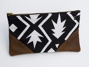 Image of a large black + white graphic print zipper clutch with leather corners + a METAL zipper