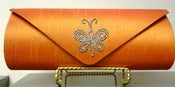 Image of Haute Latitude orange crystal butterfly clutch