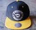 Image of THE ORIGINATORS x MITCHELL & NESS LOGO SNAP-BACK (BLACK/YELLOW)