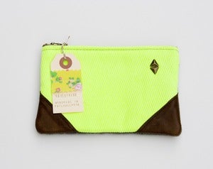 Image of small neon yellow zipper pouch with leather corners and a METAL zipper