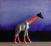 Image of black giraffe/ the strange planet