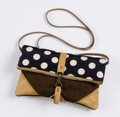 Image of foldover crossbody bag in navy + pink dots with leather corners + tassel
