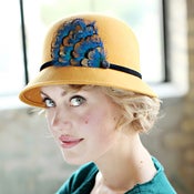 Image of Mustard Womens Cloche Hat With Peacock Blue Feather Accent
