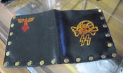 Image of Tom Fugle hand made leather wallets with stamped artwork