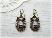 Image of Antique Brass Floral Framed Earrings with Black Monster Picture 